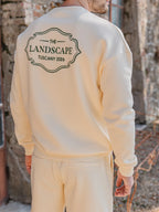 Buttergelber Oversized-Pullover mit Landschaftsmotiv